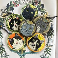 Handmade ceramic  cat portrait tile ornaments - your choice of 6 different ones.  They measure 3" in diameter. These could also be used as tree ornaments but they are not  holiday-themed - they were made to be displayed year around. Each tile is signed on the back. The video shown is not for these exact ornaments but just to give you an idea.  These hanging tiles were stamped with a custom stamp I had made of my own drawing so it is not available commercially. After the first firing I color them with underglazes and a shiny clear glaze. They are created from white stoneware clay and fired up to 2,165 degrees.  If you buy this in addition to other purchases and shipping seems high, please know that I only charge exact shipping and will refund overages. Please see my other cat ornaments here Hanging Tiles, Tile Ornaments, Underglaze Transfer, Paper Mache Clay, Black And White Tuxedo, Wood Slice Art, Custom Stamp, Gray Cat, White Tuxedo