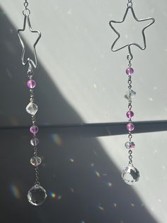 two dangling earrings with pink and clear beads