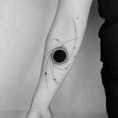 a woman's arm with a black hole in the middle