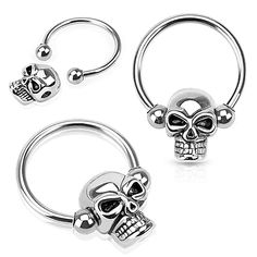 three different types of piercing rings with skulls on them