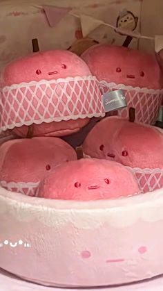 some pink donuts are in a white cake dish with lace on the top and bottom