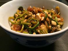 a white bowl filled with food on top of a table