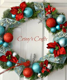 a christmas wreath with ornaments hanging on the front door