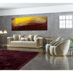 a living room filled with furniture and a painting on the wall