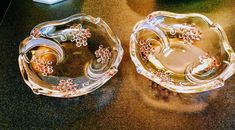 two glass dishes sitting on top of a table