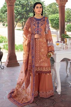 a woman in an orange outfit standing on a patio