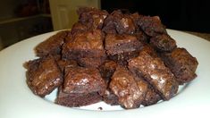 a plate full of brownies sitting on top of a table