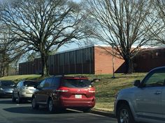 several cars are parked on the side of the road