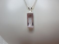 "Baguette cut Kunzite measures 17.9 x 7.4 mm and weighs 6.45 ct. The gem, sourced from Afghanistan, is light orchid pink in color. Set in sterling silver with 18\" sterling silver rope chain. All of my items are made of solid Sterling Silver and Solid Karat weight gold (no filled or plated) with natural gemstones. item # 2670" Elegant Faceted Rectangular Gemstones, Chrome Diopside Ring, London Blue Topaz Earrings, Sky Blue Topaz Ring, Silver Rope Chain, Blue Topaz Earrings, Sky Blue Topaz, Topaz Earrings, Swiss Blue Topaz