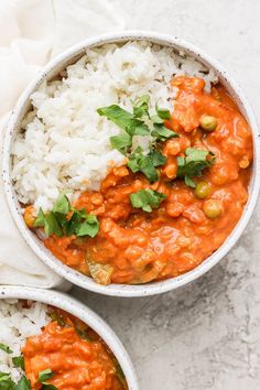 two bowls filled with rice and vegetables next to each other