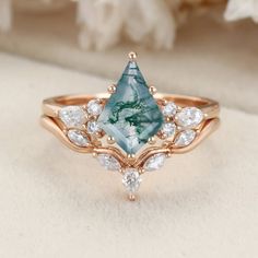 a close up view of a ring with an aqua blue stone surrounded by white diamonds