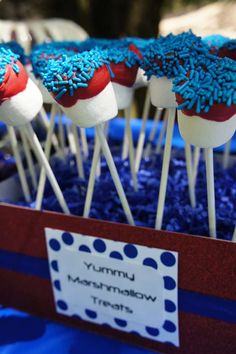 red, white and blue cupcakes with sprinkles are on sticks