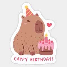 a brown bear sitting next to a birthday cake