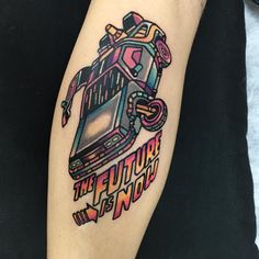 a person with a tattoo on their leg that says, the future is now in color