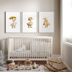 three ducks in yellow hats are hanging on the wall next to a baby's crib