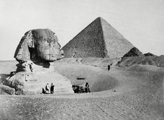 an old black and white photo of the great pyramids in egypt with people standing around