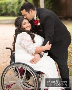 a man in a suit kissing a woman in a wheelchair