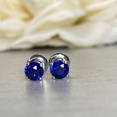 "The earrings pictured are lab created blue sapphire #5791 We feature the finest quality lab grown sapphires in the world. The properties of lab-grown are physically, chemically and visually identical to natural, just grown in a lab setting. -Approximate total carat weight: 1.00ctw diamond equivalent -Stone Size: approx. 0.50ct each diamond equivalent -Stone Shape: round 5mm each -Gem Type: lab created blue sapphire -Stone Clarity: VS2 -Stone Color: Blue -Moh's Scale: 9 hardness -Metal Type and Sapphire Birthstone Earrings In Fine Jewelry, Blue Tanzanite Earrings With Prong Setting, Sapphire Birthstone Earrings Fine Jewelry, Sapphire Birthstone Earrings For Formal Occasions, Fine Jewelry Tanzanite Earrings In Sapphire Color, Fine Jewelry Sapphire Tanzanite Earrings, Blue Tanzanite Brilliant Cut Earrings, Anniversary Tanzanite Earrings With Prong Setting, Tanzanite Earrings With Prong Setting