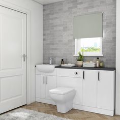 a modern bathroom with white cabinets and black counter tops, along with a toilet in the center