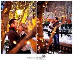 a man and woman standing under a tree covered with lights in the snow at night