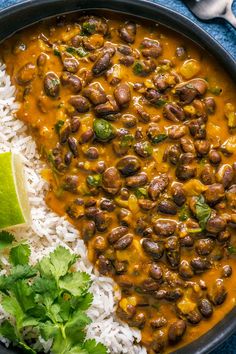 a plate with rice, beans and cilantro on it