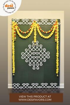 a green wall decorated with yellow and orange beads