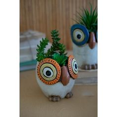 two ceramic owl planters sitting on top of a table