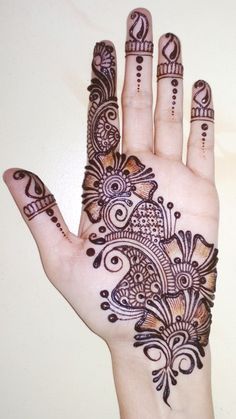 the hand is decorated with henna designs