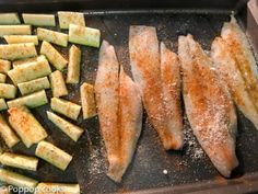 some food is laying out on a baking sheet and ready to be cooked in the oven