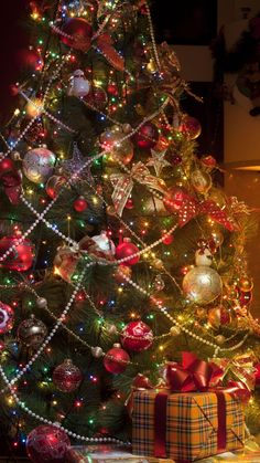 a decorated christmas tree with presents under it