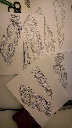 four drawings of cars are shown on the table