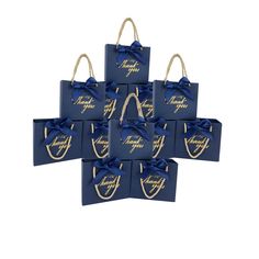 six blue gift bags with gold foil lettering and bows on the handles, all tied together