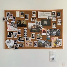 a cork board with pictures and magnets on it