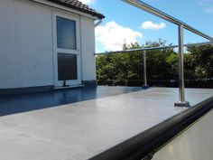 the roof of a house with an open window and metal bars on it's sides