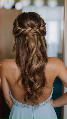 the back of a woman's head with long hair in a half - up braid