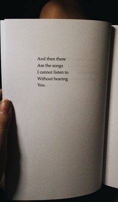 someone is holding an open book in their hand with the words and there are the songs i cannot listen to without hearing you