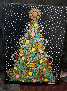 a painting of a christmas tree on a black background with white polka dots and snowflakes