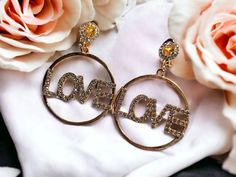 Beautiful style They hang 3 inches  large size  Reads Love in a cute metal design Secure clip on closure Gold color Clip on Trendy Gold Clip-on Earrings For Wedding, Gold Hoop Earrings For Valentine's Day Party, Pastel Earrings, Dangle Earrings Gold, Black Earrings Dangle, Red Nail, Silver Earrings Handmade, Beautiful Style, Beaded Hoops