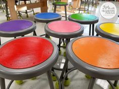 colorful stools are arranged in a circle on the floor at a store or school