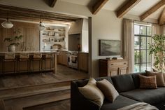 a living room filled with furniture and lots of windows