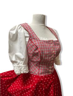 Beautiful dirndl dress red and white Bavarian crop top in perfect condition. The upper part has a corset detail and it is fully lined.   One side pocket measurements laying flat for dress and apron Distance between shoulders 32 cm Waist 72 cm length 135 cm Bust 90 cm Size on label D38  Includes also crop top  Measurements for top 100% cotton with big puffy sleeves  Distance between shoulders 32 cm Length 31 cm Bust  92 cm Sleeve length 35 cm The waist is elasticated. The top shows minor signs of Dirndl Costume, Red Dirndl Dress, Mini Dirndl Dress, Dirndl Blouse Lace, German Dress Dirndl, Floral Apron, Dirndl Dress, Puffy Sleeves, Set Vintage