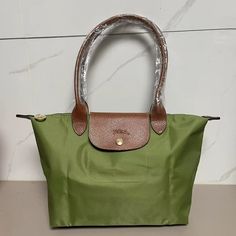 Avocado Green, Very Beautiful Golden Horse-Drawn Ring Brand New, Medium Size With Large Space, About 15.5"X9" Waterproof Material, Foldable, Easy To Carry When Going Out Golden Horse, Longchamp Bag, Green Tote Bag, Longchamp Bags, Green Tote, Brown Cowhide, Horse Drawn, Avocado Green, Gold Logo