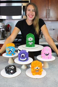 a woman is sitting in front of some cakes