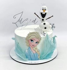 a frozen princess cake with an image of the snow queen on it's frosting