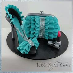 there is a cake that looks like a purse and high heel shoes on the plate