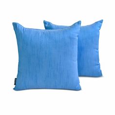 two blue pillows sitting next to each other