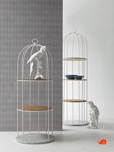 two shelves with birdcages on them, one is white and the other is brown