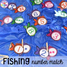 the number match is made up of fish and numbers on blue plastic wrapper with text overlay that says, fishing number match