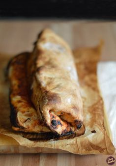 two pieces of food sitting on top of a piece of wax paper