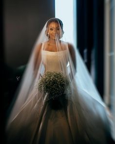 a woman in a wedding dress and veil